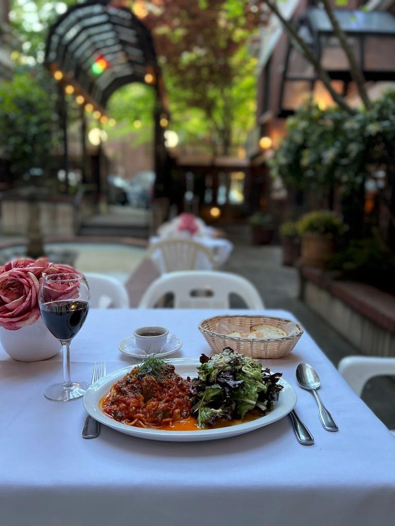 Table settled on the outside of La Fontana Siciaana with a pasta, salad, bread, wine and espresso with a great view of the Entrance, Belltown and the Fontain.